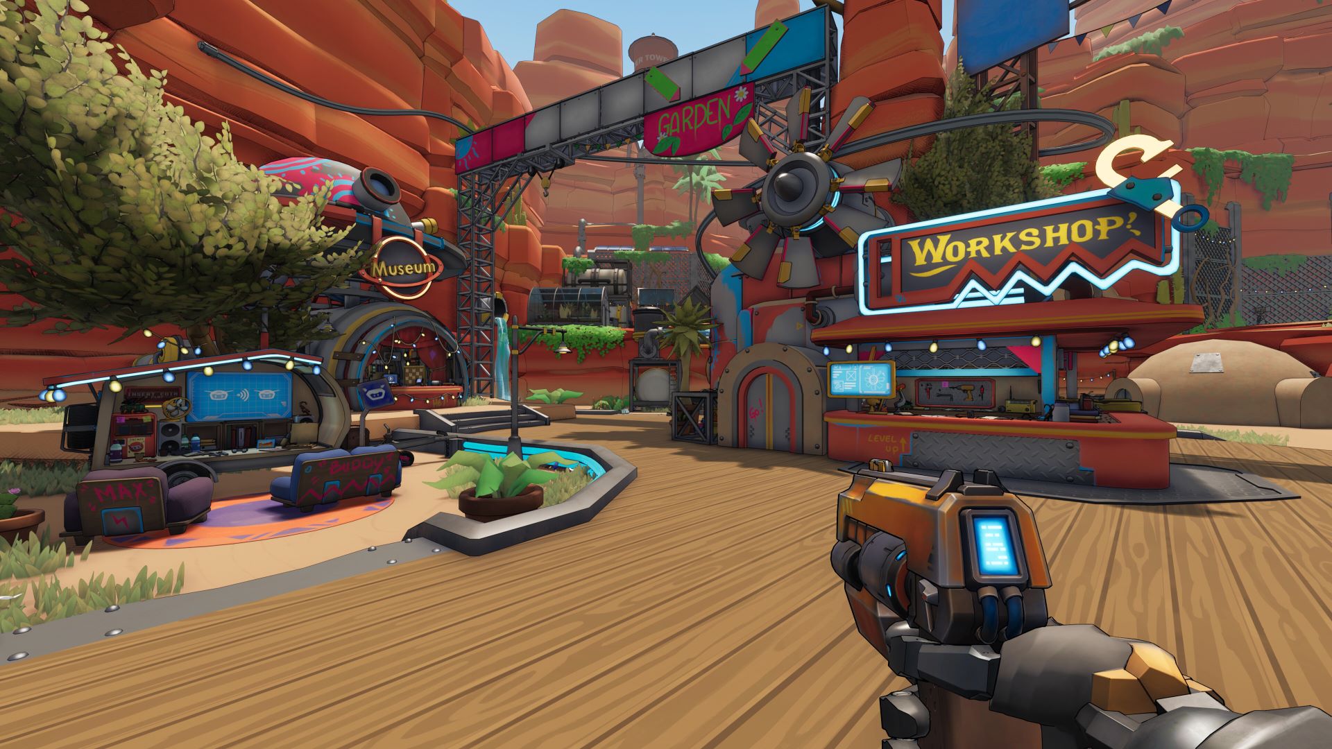 First-person screenshot from Roboquest, showing a gun pointed at a town centre in the middle of a rocky, Wild West style canyon. 