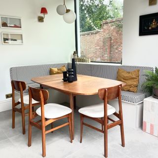 A dining room with a second-hand extendable dining table and chairs