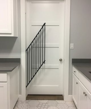 A retractable dog gate in a white kitchen