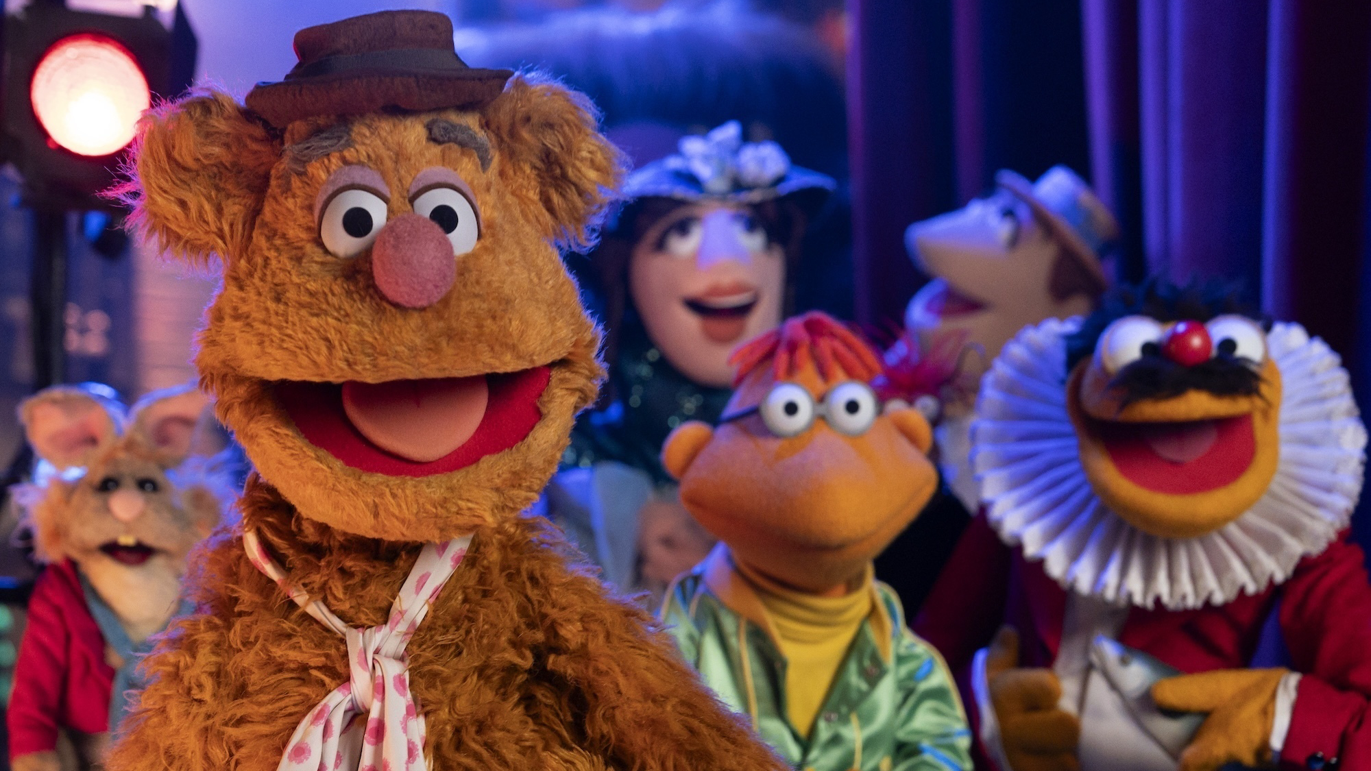 Fozzy Bear and other Muppet characters gathered in the wings of the Muppet theatre in a still from Disney+'s 2026 &amp;quot;The Muppet Show&amp;quot; special