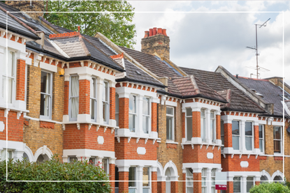 Row of traditional English terraced houses with a for sale sign in Crouch End, north London