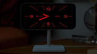 iOS 17 StandBy Mode screen showing a red clock