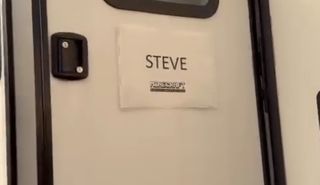 Sign saying "Steve - Minecraft" hanging on Jack Black's trailer door