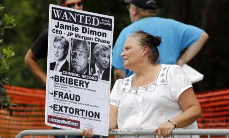 A protester stands outside the annual JPMorgan stockholders meeting Tuesday