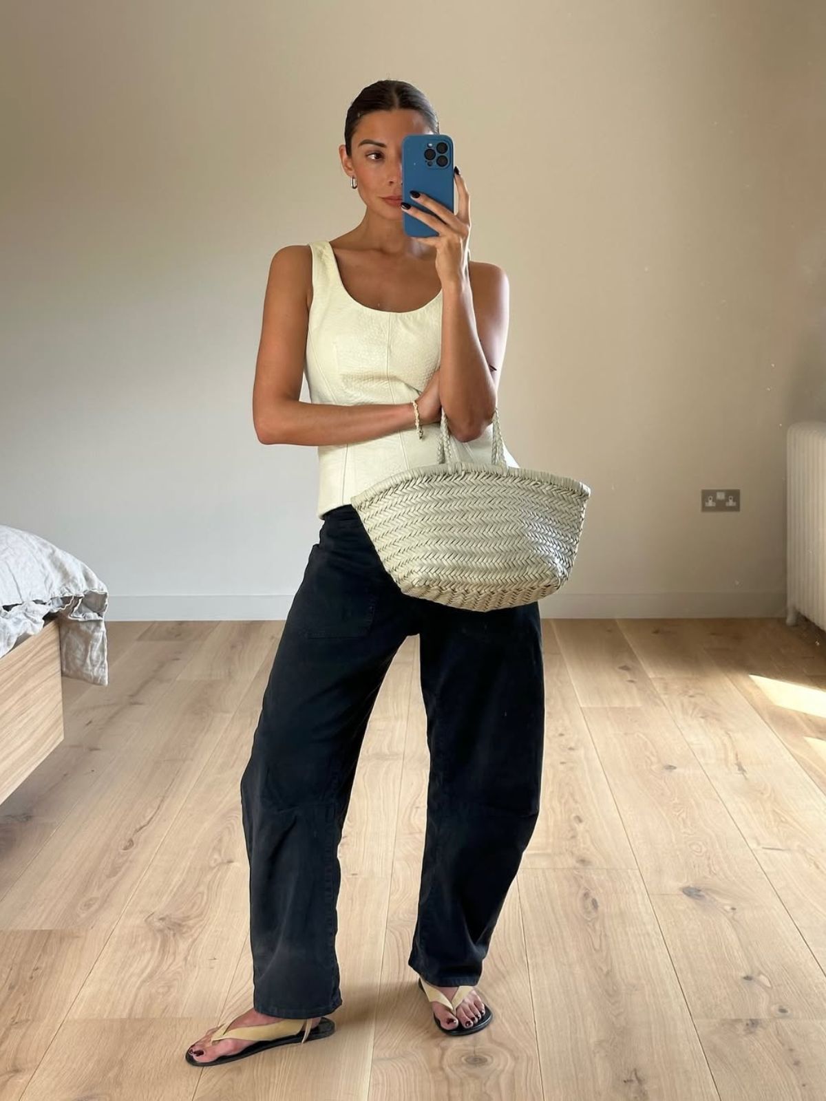 @smythsisters wearing suede sandals with jeans and a vest