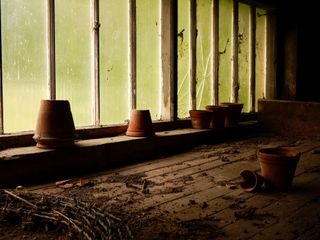 Broken terracotta pots in a dilapidated shed