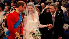Prince William, Catherine, Princess of Wales and Michael Middleton stand in Westminster Abbey on April 29, 2011