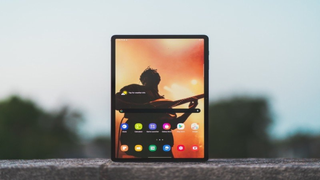 Samsung Galaxy Tab S7 Plus standing upright in portrait orientation on a rooftop ledge