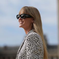 Woman with linen blonde hair wearing sunglasses