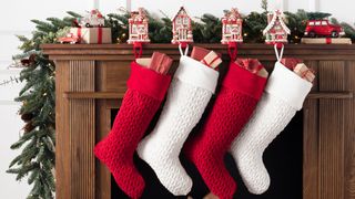 stockings on hearth fireplace with garland