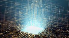 Stock image showing a computer chip shining light.