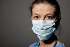 A woman doctor wearing a face mask.