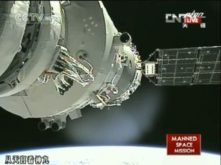 This still from a CNTV broadcast shows China's Shenzhou 9 space capsule just after it was manually docked to the Tiangong 1 space lab by astronaut Liu Wang on June 24, 2012.