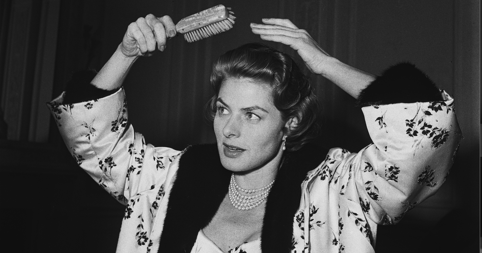 Ingrid Bergman brushing her hair.