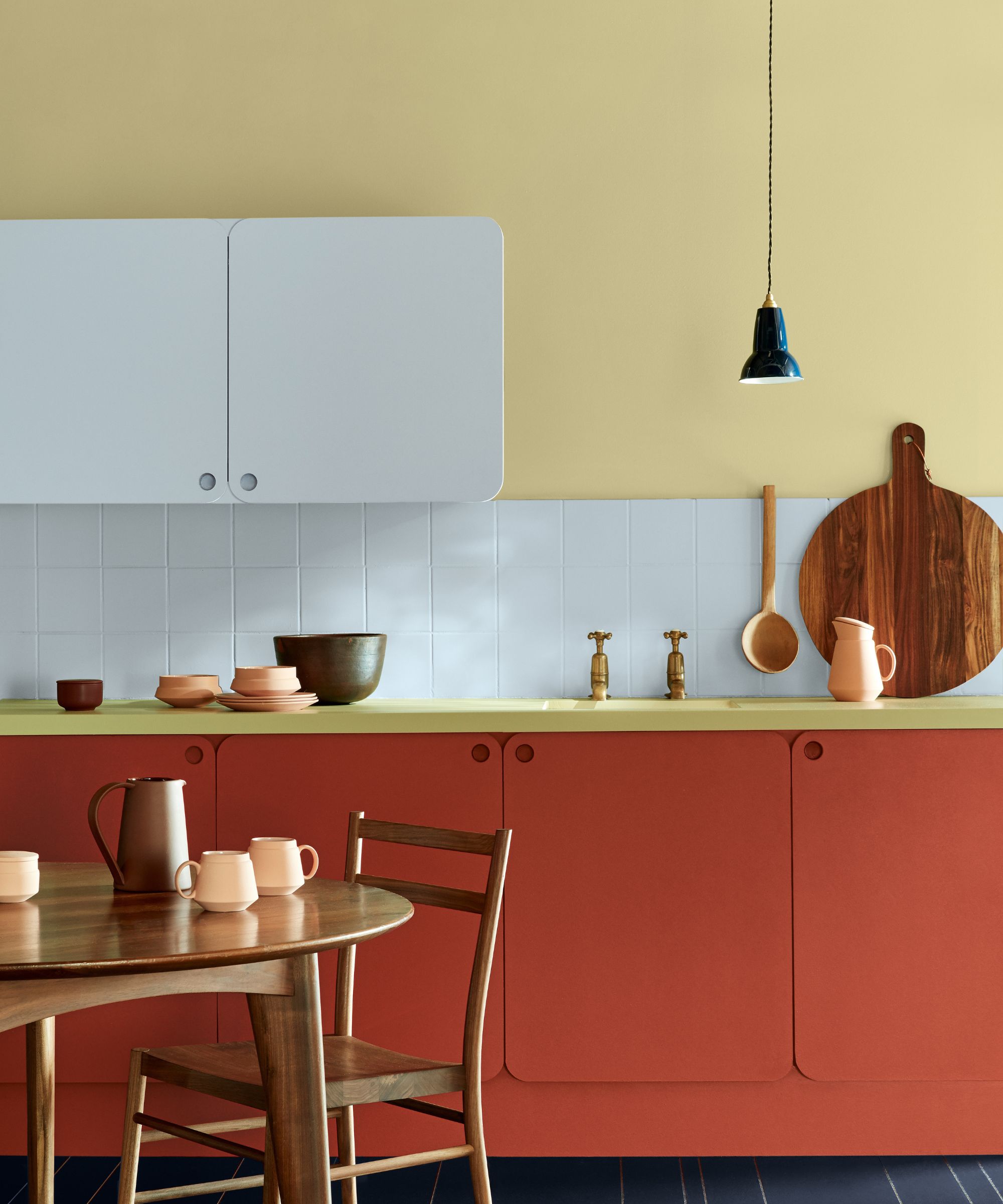 modern kitchen with butter yellow walls and red cabinets