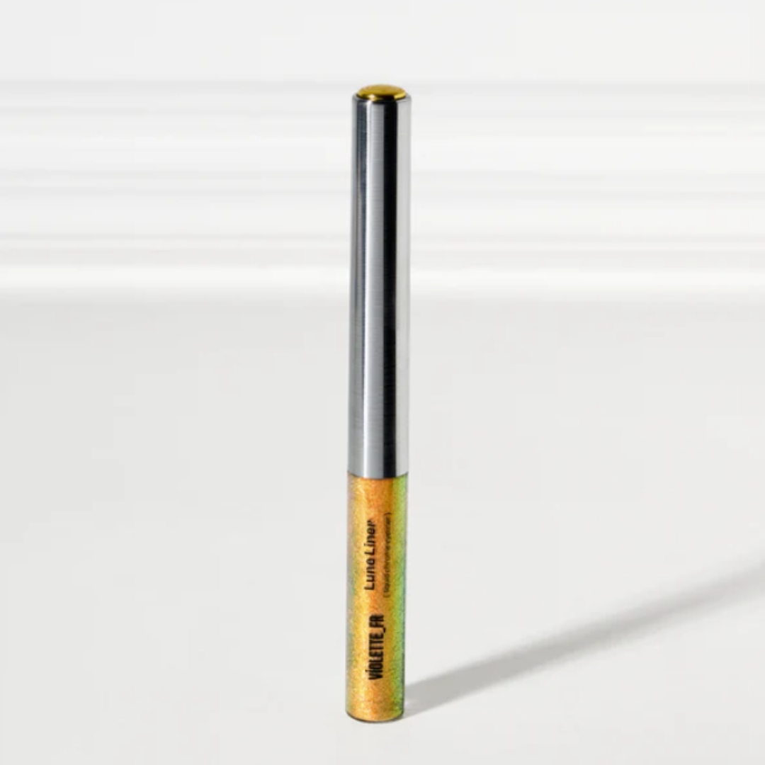 A product shot of the VIOLETTE_FR Lune Liner, which is a chrome liquid eyeliner, on a grey background