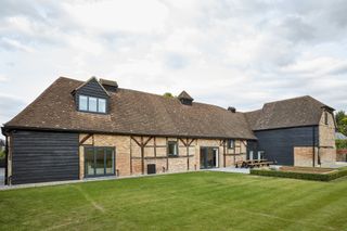 large barn conversion with lawn in front