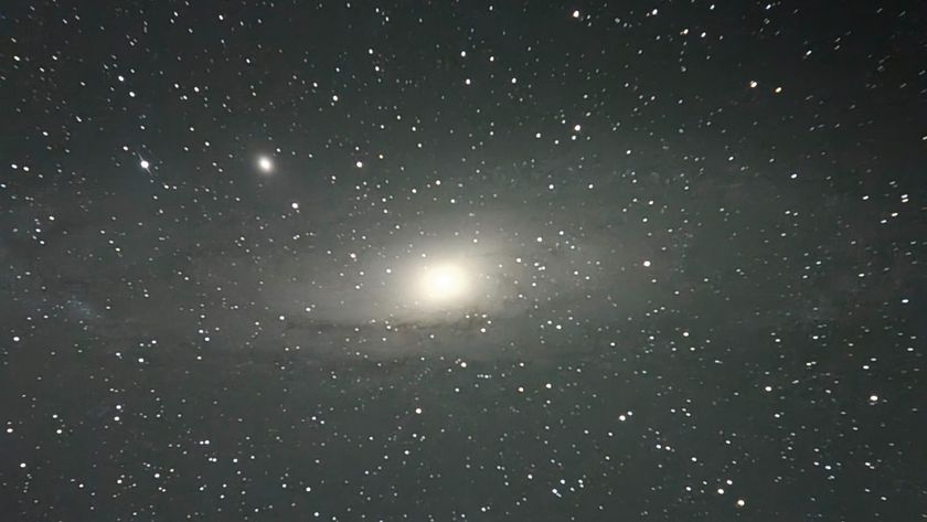 A picture of the Andromeda spiral galaxy pictured against a star-studded sky.