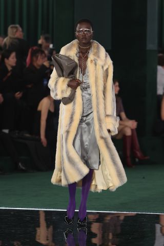 a Gucci model walks the fall/winter 2025 runway