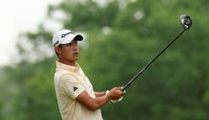Collin Morikawa strikes a driver and watches it in the air