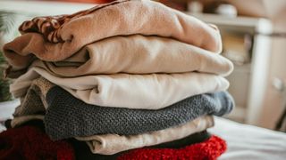 picture of folded clothes on bed