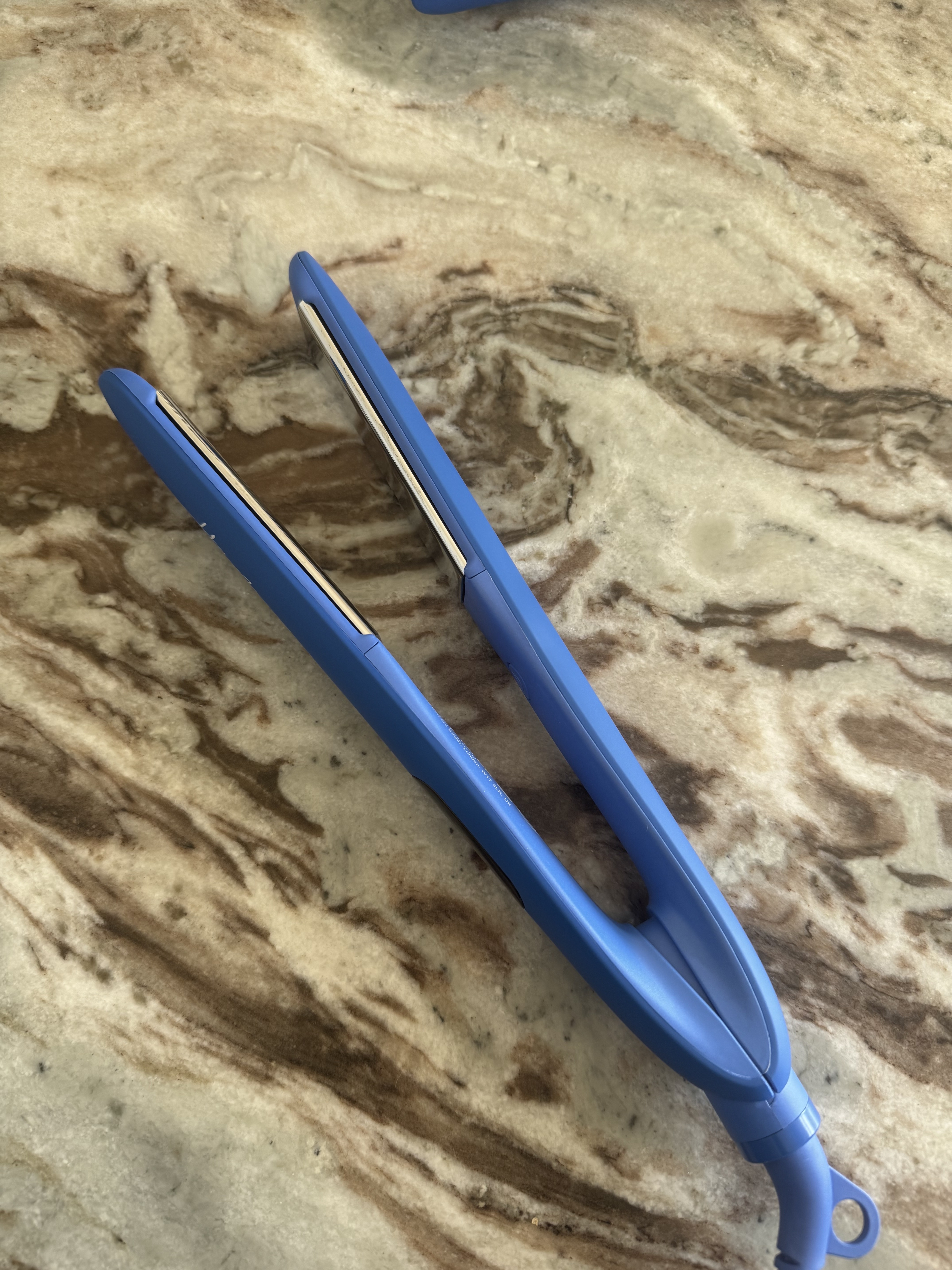 The Hershesons The Great Iron hair tool on a marble table