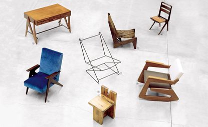 The photo shows seven pieces of furniture. Wooden desk with three drawers, blue velvet armchair with dark wood armrests, wooden stool, metal skeleton chair, Wooden chair with the tightened fabric, regular chair with beige fabric, and a rocking chair in light wood, white and olive fabric.