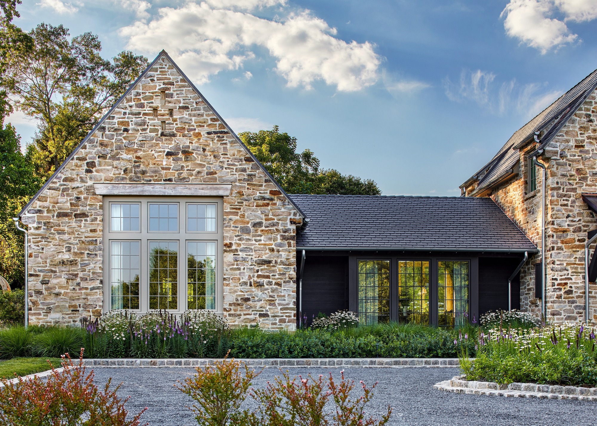 beautiful home with stone exterior and driveway