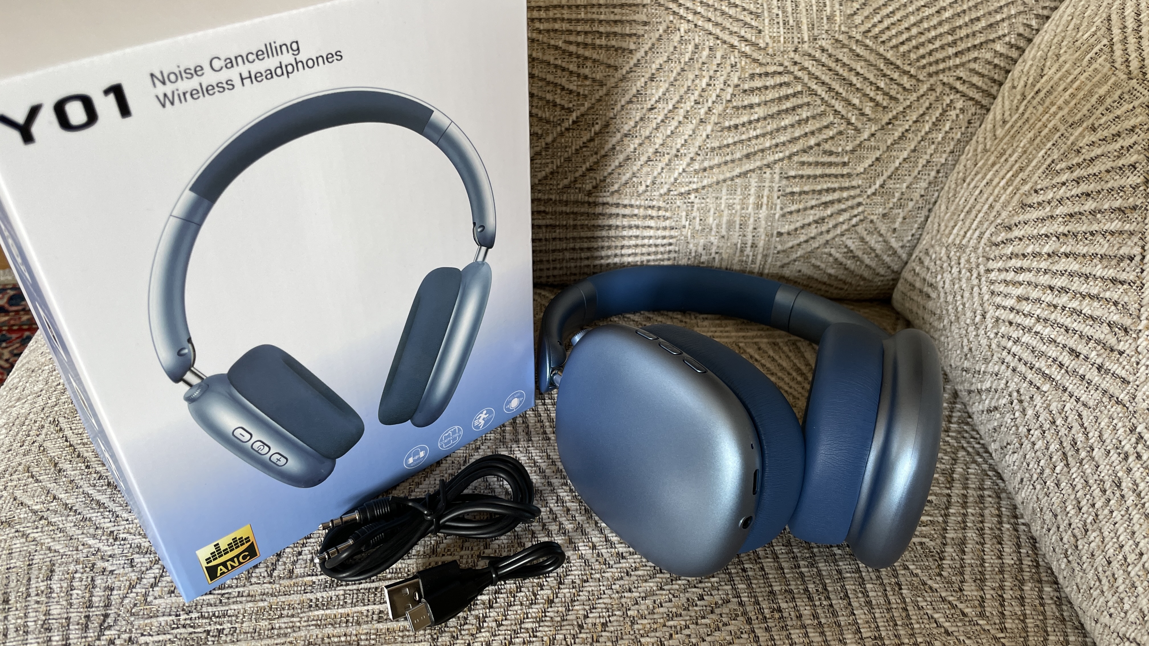 Wentronic YO1 (AirPods Max dupe) headphones in blue with AirPods Max nearby to compare and contrast their looks, outside on a sunny day