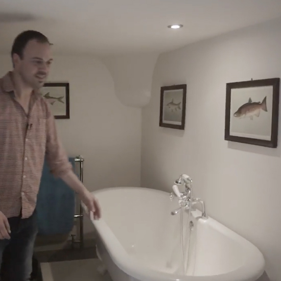 bath tub in bathroom with wall frame