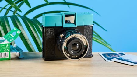 A black and teal Lomography Diana Instant Square instant camera