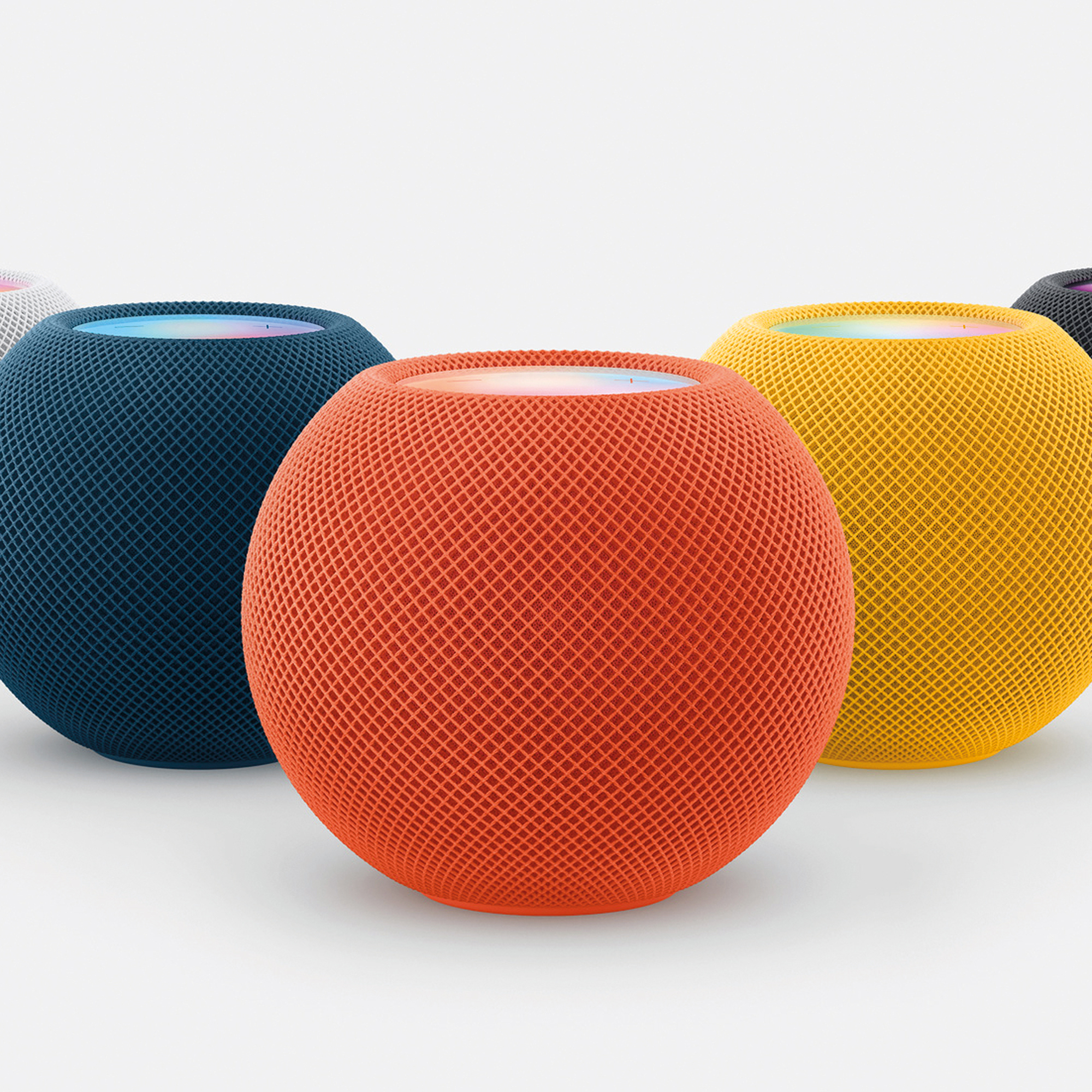 a row of Apple Homepod Minis in various colours