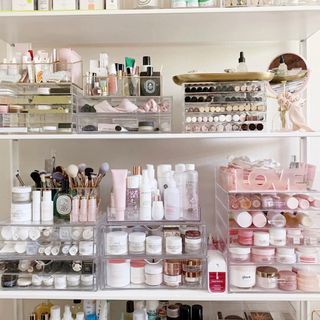 Open shelving cabinet with makeup assortment in clear makeup organizers