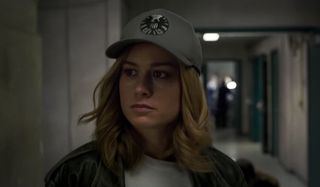 Brie Larson as Carol Danvers wearing SHIELD hat in Captain Marvel