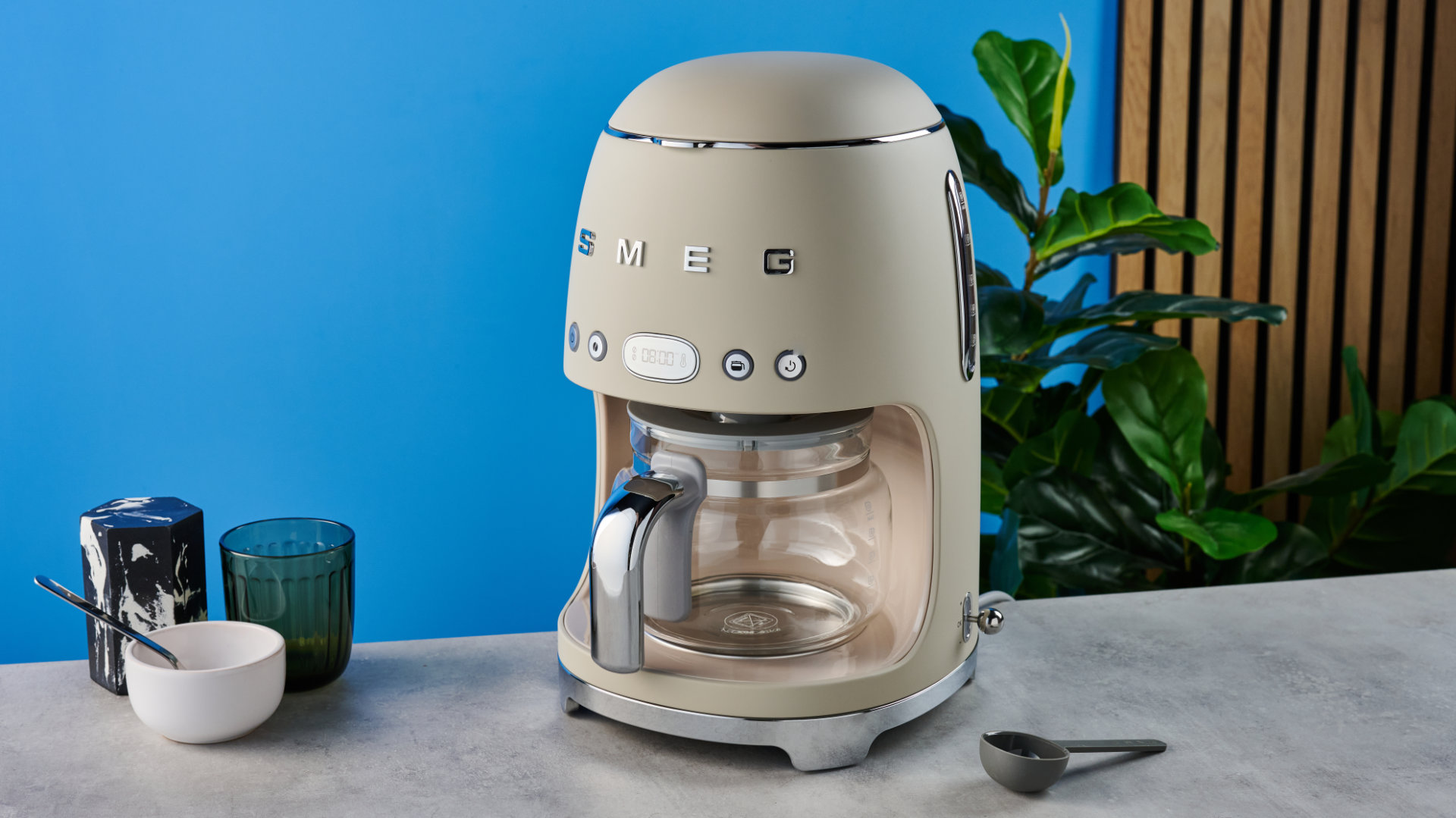 the smeg retro coffee maker photographed against the blue tom's guide background