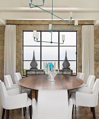 dining room with oval wood table and white upholstered chairs