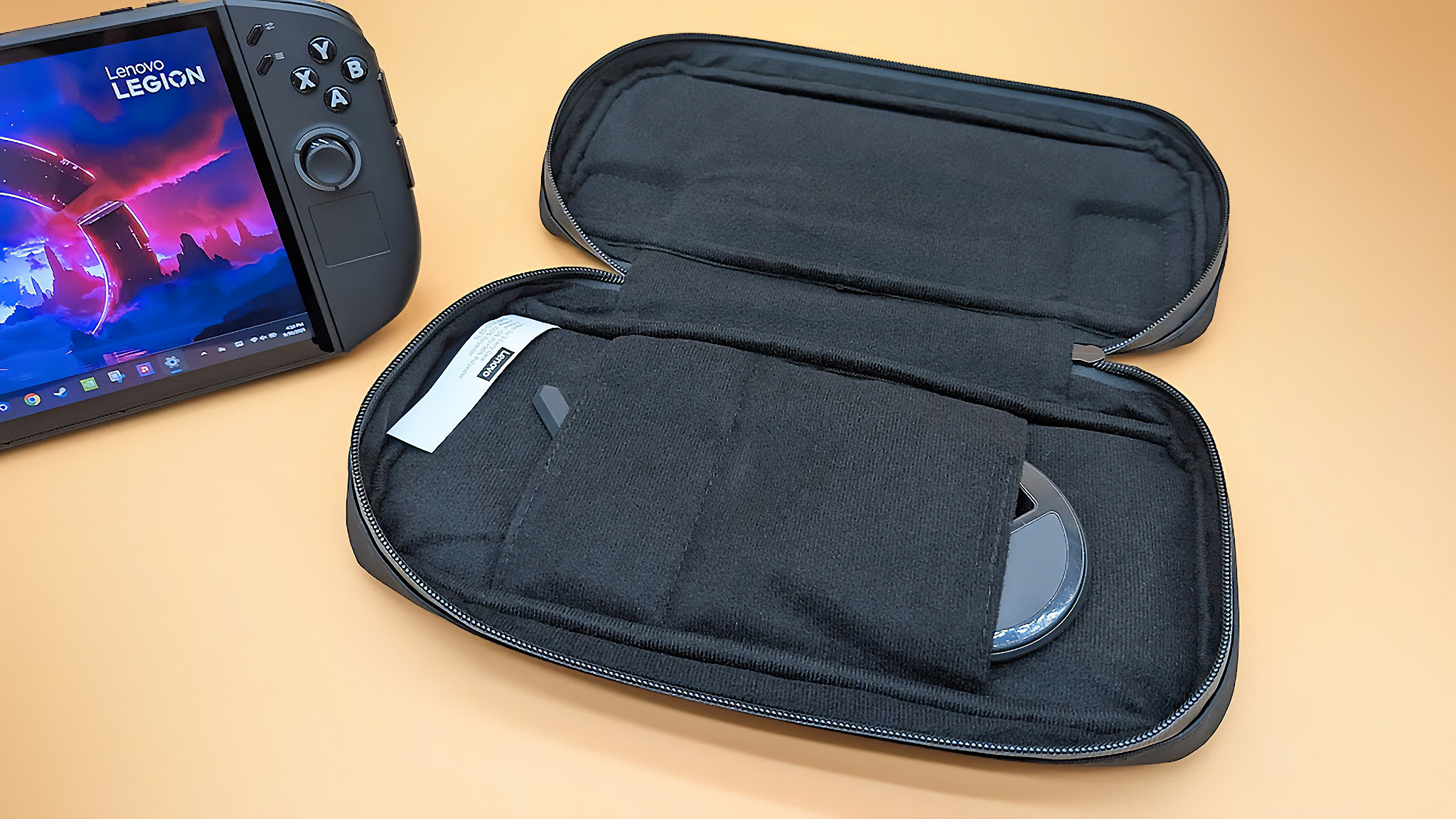 The Lenovo Legion Go 2 case lying open with the FPS mode controller dock and a controller pin cover accessory sticking out from some pockets.