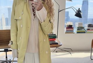 Olympia Gayot wearing a trench coat from the J.Crew Labor Day sale.