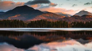 Scenic view of lake by mountains against sky during sunset, Keene Valley, New York