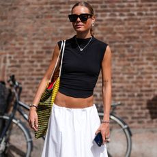 womani n black top and white skirt