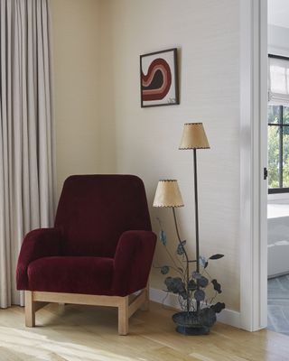 A living room corner decorated with an accent chair and lamp