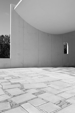 Black and white image of a roof curving downwards, and a tiled floor