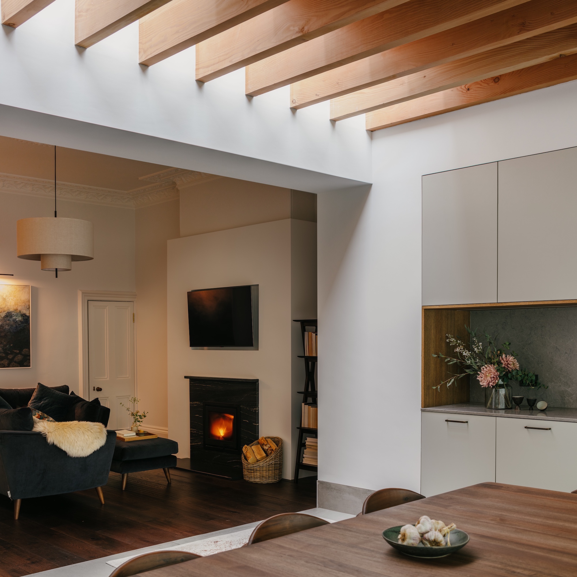 dining living area with view of table and seating space with tv and fire