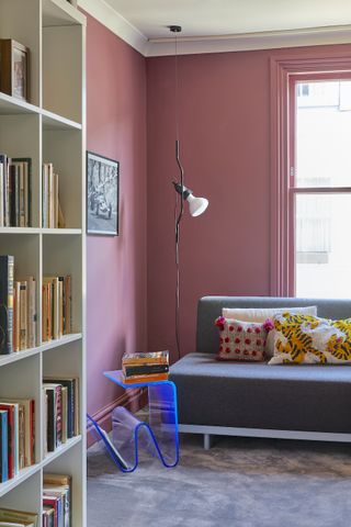 A room with a pink accent wall