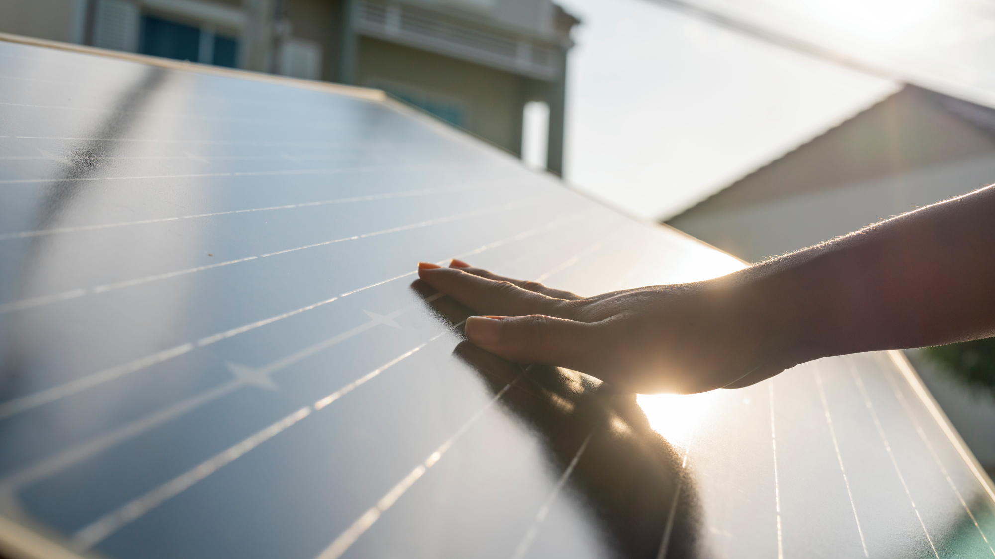 hand touching solar panel