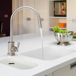 kitchen room with white sink and steel tap