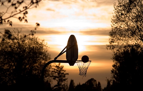 Basketball enters hoop on playground court