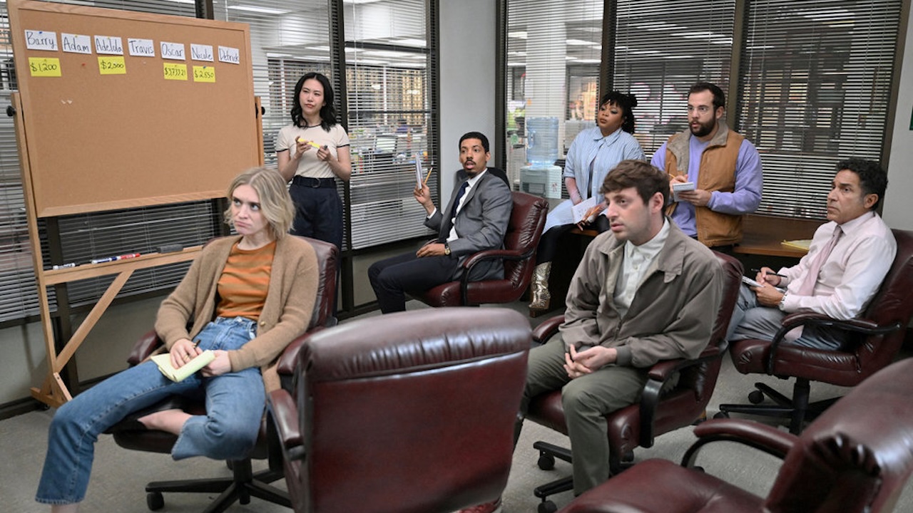 Staff members sitting around a room in The Paper