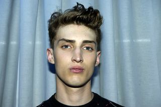 male model headshot with light hair styled upwards