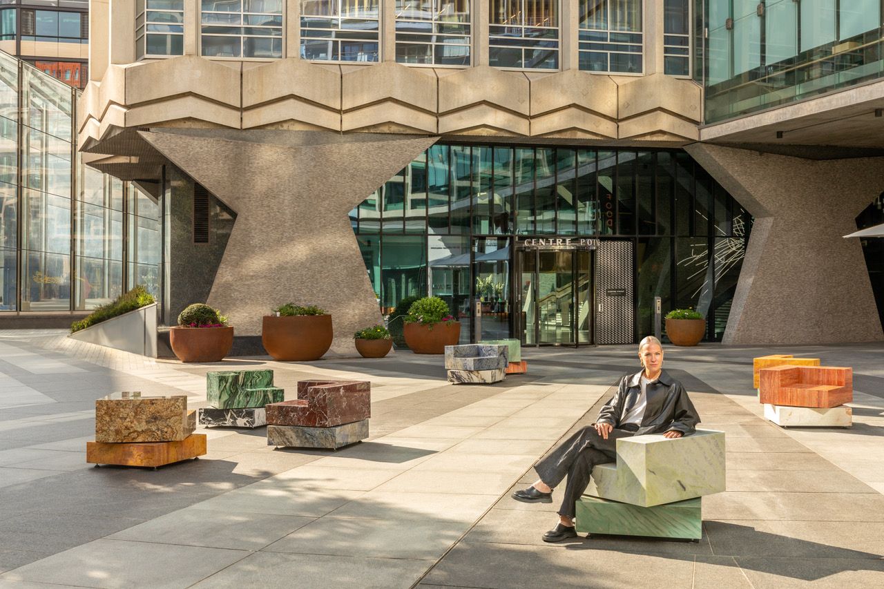 Sabine Marcelis sitting on one of the marble seats she created for London Design Festival